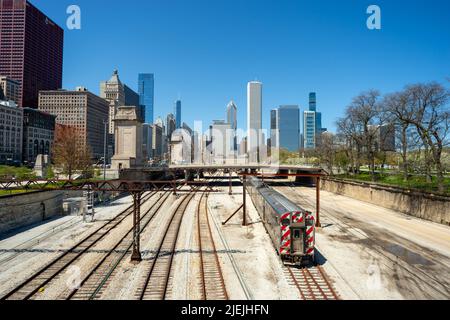 Railroad lines or tracks in Chicago with the skyline in the background against blue sky. Chicago, IL, USA Stock Photo