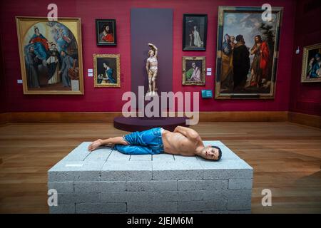 Juxtaposition in the Fitzwilliam Museum Cambridge England UK 26 June 2022 St Sebastian by Spanish Artist Alonzo Berruguete 1525 in the background and Action 125, Tikrit City, Iraq Prisoner of war. Monday April 14, 2003 by London based Iranian Born artist Reza Aramesh created in 2011 Stock Photo