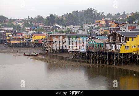 Traditional wooden stilt houses, palafitos, at Castro in Chiloe Island, Chile. Castro was founded in 1567 and it is the Chile's third oldest city. Stock Photo