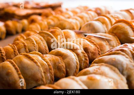 freshly baked empanadas with different fillings for sale Stock Photo