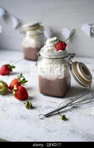 Breakfast hot chocolate with fresh cream.Healthy milk and sweet strawberries. White background Stock Photo