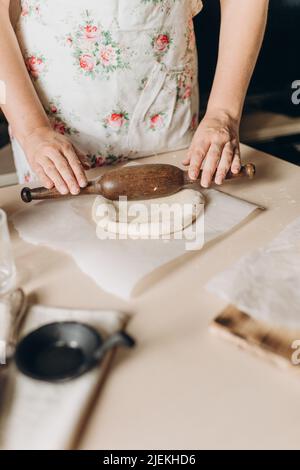 the process of making dough in the kitchen at home, home cooking, female hands prepare food Stock Photo