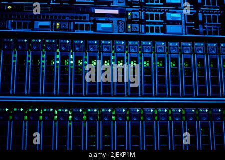 Graphic background image of blade servers in blue neon light stacked in data center, copy space Stock Photo
