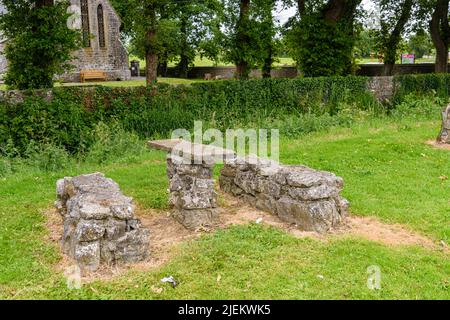 Picnic table and benches made from ancient stone in a park. Stock Photo