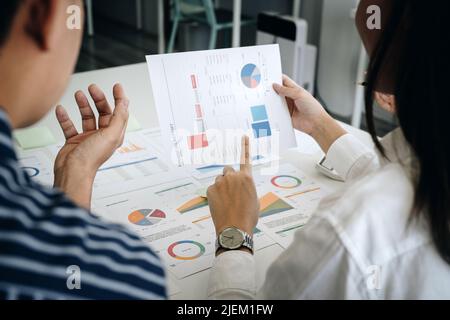 Business adviser analyzing financial figures denoting the progress in the work of the company Stock Photo