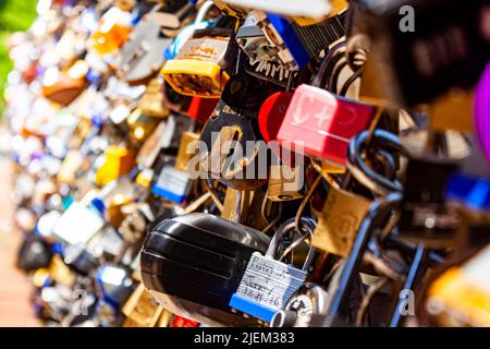 Love locks on a bridge, commemorative padlocks placed by romantic couples to memorialize their relationship, affection, relationships concept Stock Photo