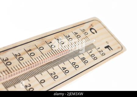 A wooden temperature thermometer isolated against a pure white background with red mercury Stock Photo