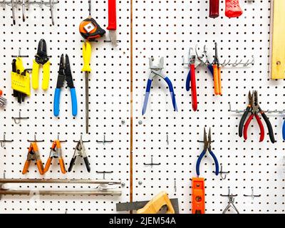 Tools hanging on a pegboard Stock Photo