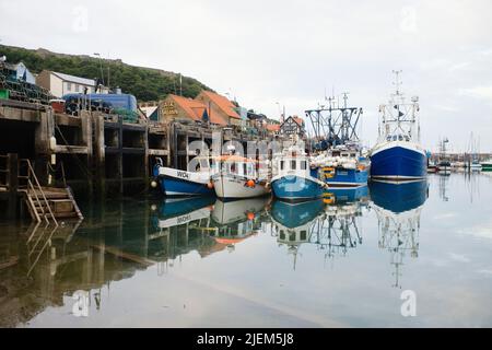 Fishing boats moored alongside the quay in Scarborough harbour Stock Photo