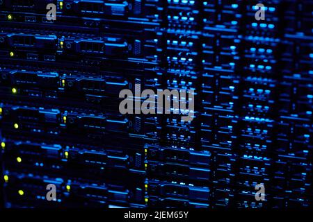 Background image of blade servers stacked in data center with blinking neon lights, copy space Stock Photo
