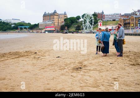 Family eating ice creams on the beach at Scarborough during a weekday evening when it is relatively quiet Stock Photo