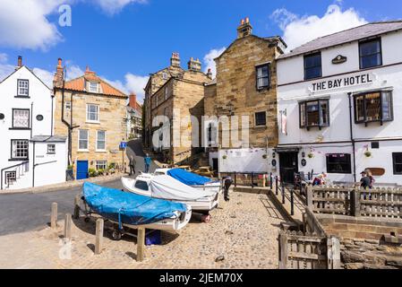 Robin Hood's Bay Yorkshire The Bay Hotel with fishing boats in front in the village of Robin Hood's Bay Yorkshire North Yorkshire England UK GB Europe Stock Photo
