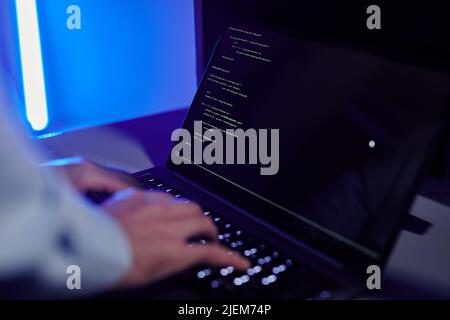 Close up of IT engineer writing code at laptop and setting up server network, copy space Stock Photo