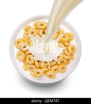 Corn rings with pouring milk isolated on white background, top view Stock Photo