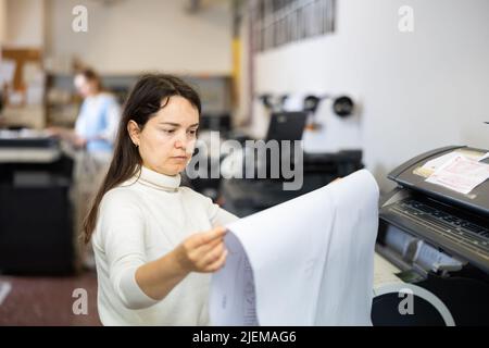 Worker in a printing and press centar check print quality Stock Photo
