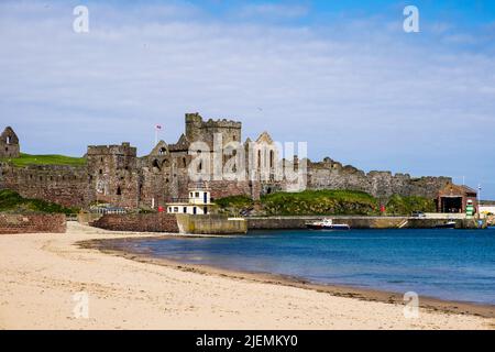 Peel castle ruins and sandy beach in the Bay. Peel, Isle of Man, British Isles, Europe Stock Photo