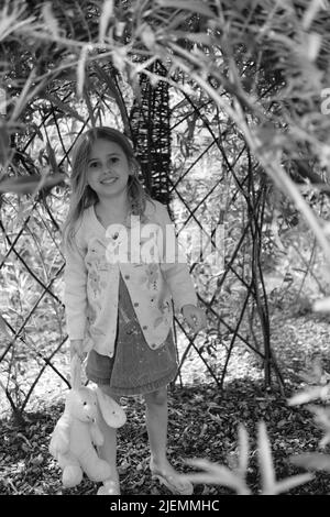 Girl, aged 5, playing in the park Stock Photo