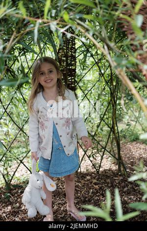 Girl, aged 5, playing in the park Stock Photo