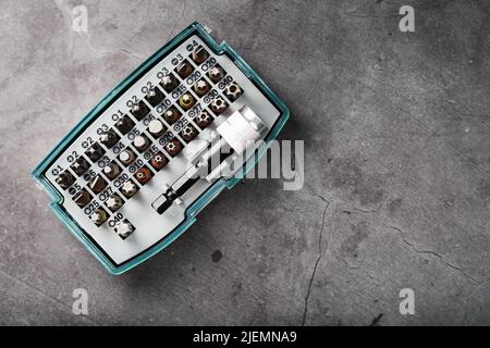 A set of metal bits for screwdrivers in a box. Hexagon head of different sizes Stock Photo