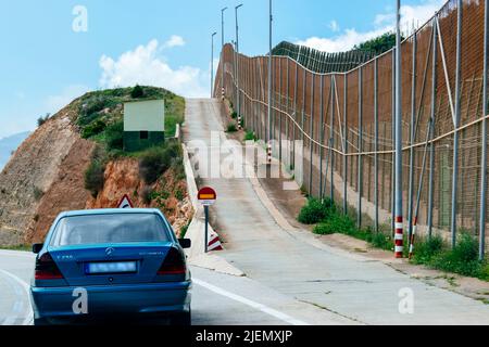 The Melilla border fence forms part of the Morocco–Spain border in the city of Melilla. Constructed by Spain, its stated purpose is to stop illegal im Stock Photo