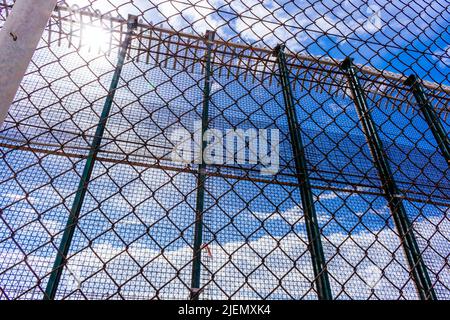 Fence that separates the city of Melilla from the Moroccan port of Nador. The Melilla border fence forms part of the Morocco–Spain border in the city Stock Photo