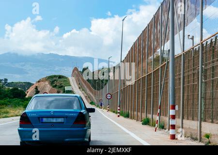 The Melilla border fence forms part of the Morocco–Spain border in the city of Melilla. Constructed by Spain, its stated purpose is to stop illegal im Stock Photo