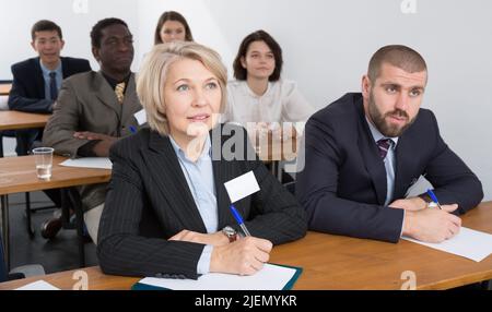 People during business seminar in lecture hall Stock Photo