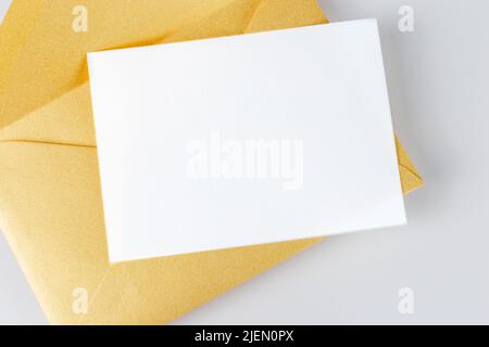 VIP invitation template mockup with blank paper sheet and golden envelope Stock Photo