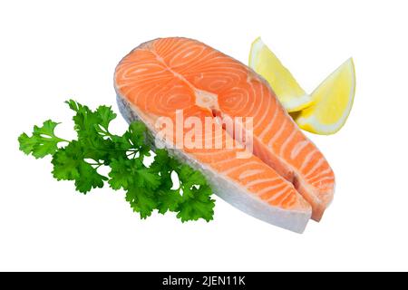 Raw salmon steak isolated on white with parsley and lemon Stock Photo