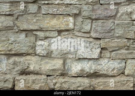 Old gray stone wall. Stone background from gray old stones. Stock Photo