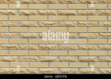 Solid yellow and beige brick wall. Brick background. Stock Photo