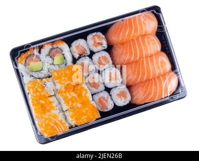 Sushi delivery box isolated on white. Japanese set menu in black transparent box. Top view Stock Photo