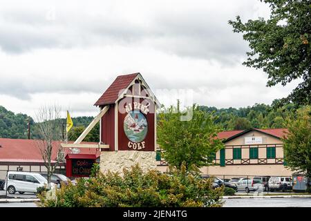 Helen, USA - October 5, 2021: Helen, Georgia Bavarian village town during Oktoberfest festival with Alpine Golf sign by building for mini golf on clou Stock Photo