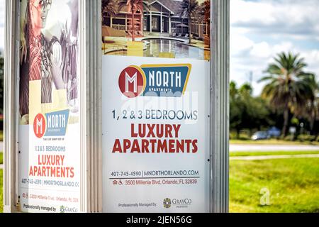 Orlando, USA - October 19, 2021: Billboard bus stop advertisement for luxury 1 2 and 3 bedroom apartments in north Orlando, Florida city Stock Photo