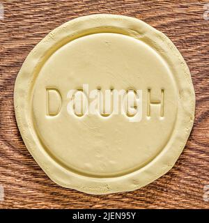A piece of dough on an oak wood cutting board Stock Photo