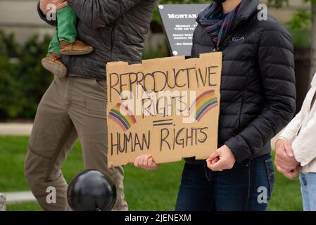 Helena, Montana - June 24, 2022: Woman holding reproductive rights are human right sign at state capitol to protest overturning roe vs wade by SCOTUS Stock Photo