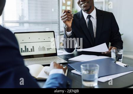 Cropped shot of two smiling business people discussing deal during meeting in office Stock Photo