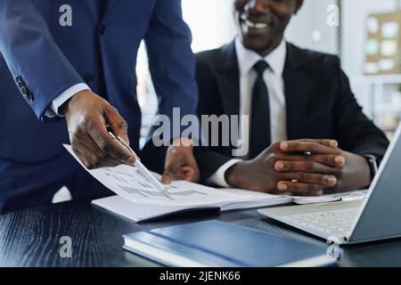 Close up of black business manager analyzing financial report during meeting in office, copy space Stock Photo