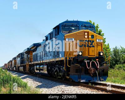 CSX Transportation #345, a GE AC4400CW diesel locomotive, leads additional locomotives pulling freight in Montgomery Alabama, USA. Stock Photo