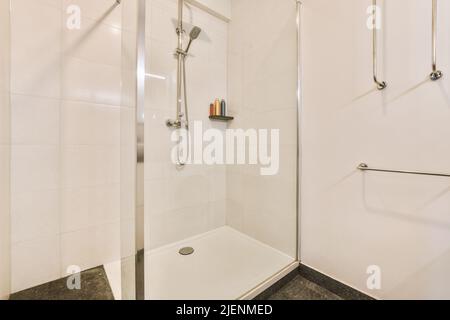 Stylish bathroom interior design with glass shower with shelf in modern apartment Stock Photo