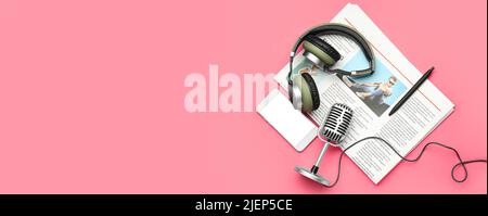 Headphones with microphone, mobile phone and newspaper on pink background with space for text Stock Photo