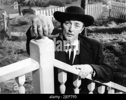 ROBERT MITCHUM portrait as Harry Powell in THE NIGHT OF THE HUNTER 1955 director CHARLES LAUGHTON novel Davis Grubb screenplay James Agate cinematographer Stanley Cortez music Walter Schumann Paul Gregory Productions / United Artists Stock Photo