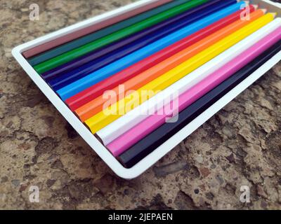 Banner of color pencils on light gray blue background. Top view with space for text. Back to school concept. Flat lay stationery mockup. Bright backpl Stock Photo