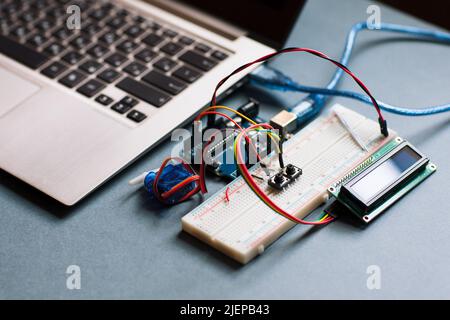 Electrical breadboard connected to computer Stock Photo