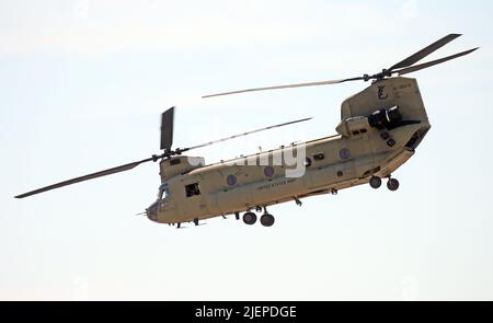 27 June 2022, Brandenburg, Schönefeld: The Boeing CH-47 Chinook helicopter flies on the grounds of the International Aerospace Exhibition ILA. The helicopter is a twin-engine transport helicopter with a tandem rotor arrangement. The German government wants to buy the American aircraft. The air show at Schönefeld Airport will be open from June 22-26, 2022. Photo: Wolfgang Kumm/dpa Stock Photo