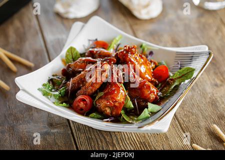 Closeup on portion of glazed chicken wings Stock Photo