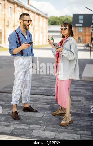 Young hipsters hang out together near office outdoors Stock Photo