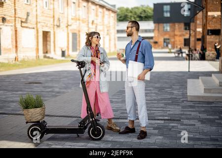 Stylish colleagues meet together outdoors Stock Photo