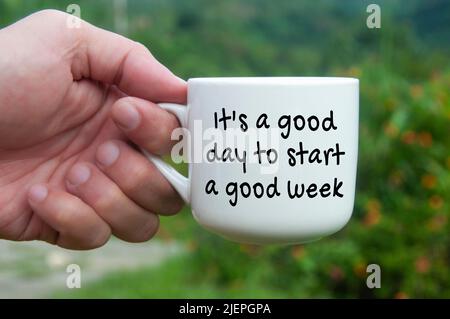 It is a good day to start a good week text on coffee cup. New day concept Stock Photo