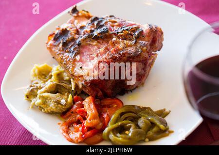 Broiled pork knuckle with vegetable garnish Stock Photo